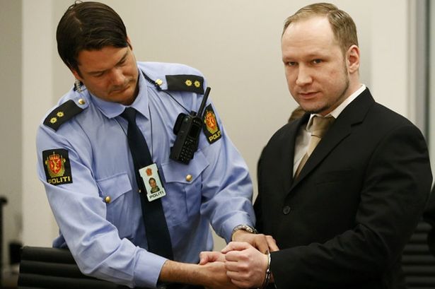 Defendant+Norwegian+mass+killer+Anders+Breivik+has+his+handcuffs+removed+after+arriving+in+the+courtroom+in+Oslo