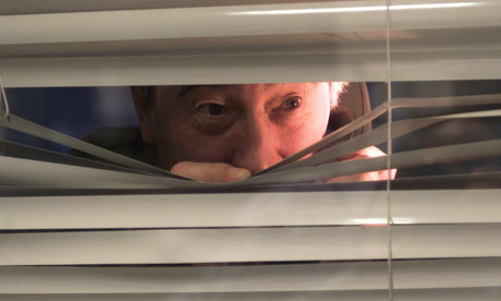 A-man-peering-through-a-s-002.jpg